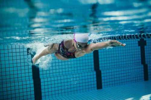 cool underwater shot of woman swimming laps